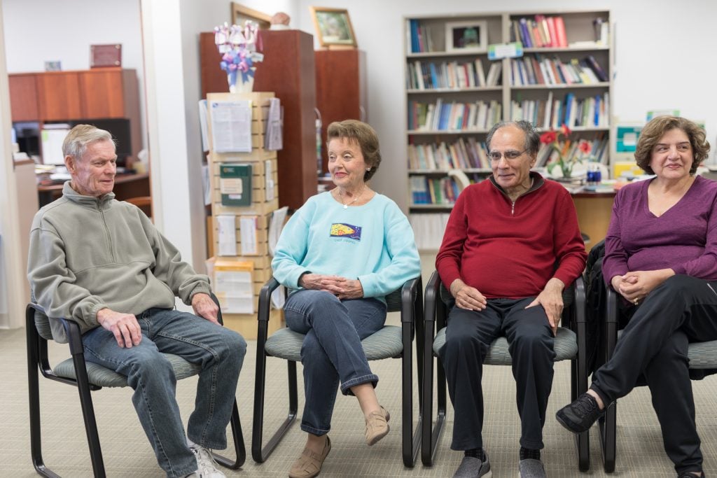 Group of people with Parkinson's Disease sitting in a circle at a support group.