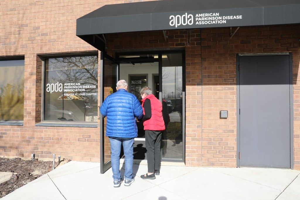 A couple walking into the APDA building.