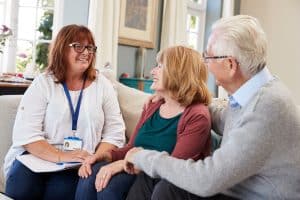 social worker talking with older couple